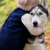 A young girl hugging her pet dog, parents separation