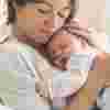 Mum cuddling her sleeping baby