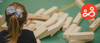 Young girl in a play area looking at a collapsed Jenga tower