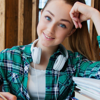 A cheerful young woman completing her course work 