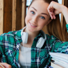 A cheerful young woman completing her course work