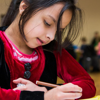 A young girl is drawing a picture at a Birmingham Children's Centre over the Christmas period