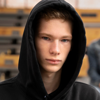 Teenager looking at the camera wearing a hoodie.