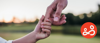 A child reaches out to hold their parents hand