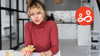 Teenager holding a sandwich at the kitchen table