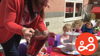 A teaching assistant helping out at Buttons pre-school, during an event to celebrate the coronation of King Charles