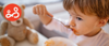 Young child eating his meal whilst enjoying the company of his family