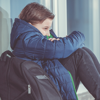 A boy sat alone reflecting after being bullied