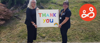 Two team members of HMP Winchester holding a 'thank you' sign, in response to the recognition they received for their work during the pandemic