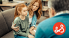 an anxious child is sat with mother and counsellor