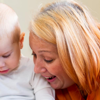 A toddler and childcare worker engaging in a fun activity 