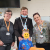 A prisoner's family visiting services and young boy, pose for a photo during Birthday celebrations