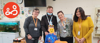 A prisoner's family visiting services and young boy, pose for a photo during Birthday celebrations