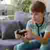 Boy gaming alone on a sofa