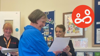 A volunteer receiving an award for her work as a volunteer providing support to prison families.