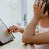 A bored looking young girl searching the web on a tablet device