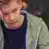Teenage boy with his hand on his face