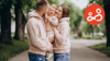 Parents holding their child together in a park