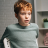 A young boy is sat receiving a counselling session. 