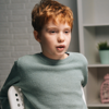 A young boy is sat receiving a counselling session.