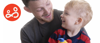 A father shares a happy moment with his son, who is playing with a toy