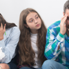 A child sat between her two worried parents.