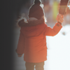 A mother and child holding hands on a walk