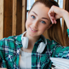 A smiling young woman revising for an exam 