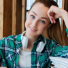 A smiling young woman revising for an exam