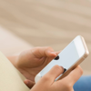 A young woman is typing on her smart phone