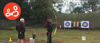 A young woman practicing archery with an instructor at an activity day organised by Spurgeons' BeLeave project 