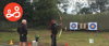 A young woman practicing archery with an instructor at an activity day organised by Spurgeons' BeLeave project
