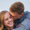 A teenage couple in their first romantic relationship, hugging outdoors