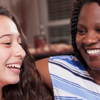 A parent and child receiving good news on exam results day.