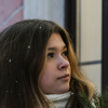 Young person looking into a shop window at Christmas