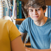 Teenage boy smiling at the camera during a counselling session.