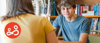 Teenage boy smiling at the camera during a counselling session.